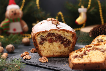 Christmas cupcake with nuts, covered with icing sugar on the Christmas background. Closeup....