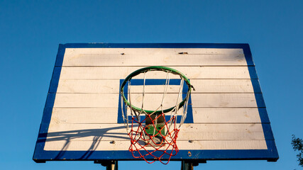 Basketball hoop, shield on a background of blue sky. Street basketball