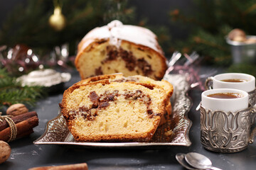 Christmas cupcake with nuts, covered with icing sugar on the Christmas background. Closeup