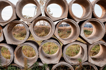 Concrete pipes. The texture is round gray. Materials for construction. Texture. Geometry.