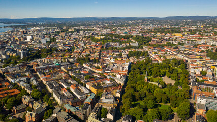 Fototapeta na wymiar Oslo, Norway. Beautiful panoramic aerial view photo from flying drone for Oslo city center. Against the background of the sea, mountains and blue sky on a sunny summer day. (Series)