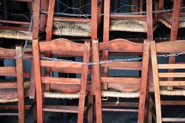 Greece, Athens, November 3 2020 - Chairs, tables and other furniture stacked outside closed cafe-restaurant, after the announcement for Covid-19 lockdown.