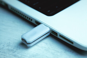 Modern USB drive on laptop keyboard