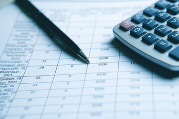 Close up calculator and financial report - accounting concept
