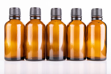 Small glass bottles for the storage of light-sensitive liquids. Containers used in pharmaceuticals.