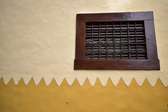 yellow plaster wall with square window