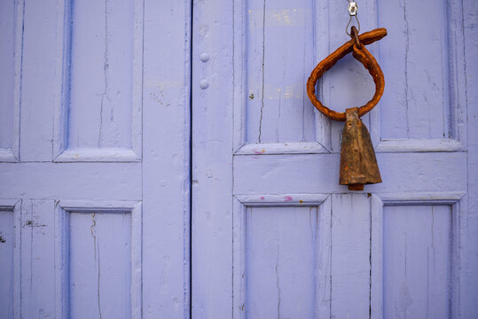 old door with a bell for cows