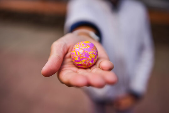 multicolored rubber ball in outstretched hand