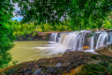 A small waterfall in the deep forest of the border of Thailand and Cambodia,Wang Yai  waterfall in tropical forest,Sisaket province,Thailand. Leaf moving low speed shutter blur.