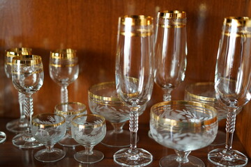 Glass holiday tableware in a mahogany Cabinet.
