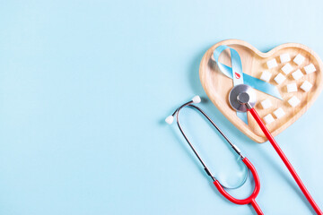 World diabetes day awareness concept, stethoscope with blue ribbon on pastel background, 14 November.