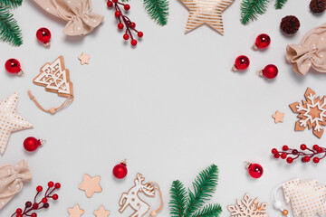 Fototapeta na wymiar Christmas frame with decorations on gray background