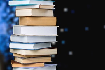 Collection of old books stack on dark background