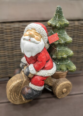 Figure for Christmas decoration of Santa Claus carrying a Christmas tree on a motorcycle