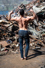 Man Showing His Body in Industrial Junk Yard