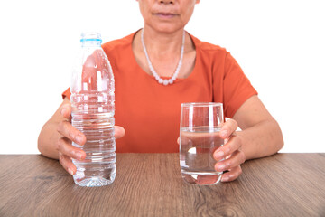 Women at the table in front of white background are about to drink water