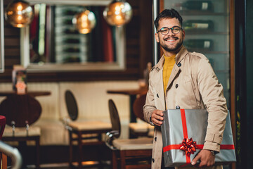 a cheerful young man, with a present