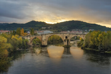 Fototapeta na wymiar Roman Bridge of Ourense in a sunset with a spectacular light