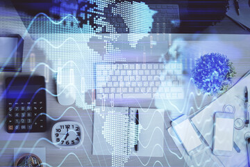 Multi exposure of forex graph drawing over desktop background with computer. Concept of financial analysis. Top view.