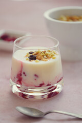 Yogurt with raspberries and crunchy granola. Healthy food. Close up.