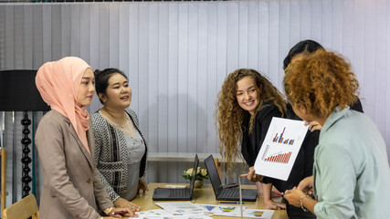 Business women from different ethnic races and cultures working together in an office for business development or plan