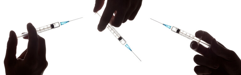 Hand holding syringe with vaccine against corona virus.