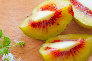 Red kiwi fruit cultivars halves close up