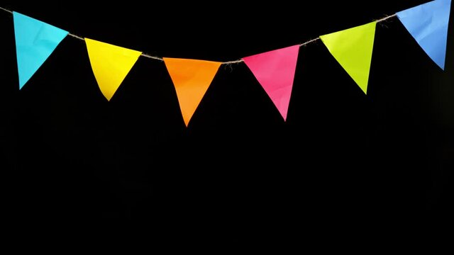 Party Banners Decoration flags on Black Background. Super Slow Motion.