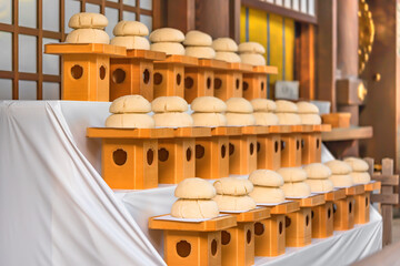 Fototapeta na wymiar Traditional Japanese New Year decorations named Kagami mochi or mirror rice cake which are lined up in the Meiji Jingū Shrine of Tokyo during the anniversary of the birth of Meiji Emperor in november.