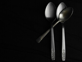 spoon and fork on black