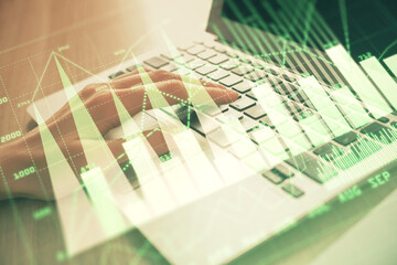 Double exposure of woman hands typing on computer and forex chart hologram drawing. Stock market analysis concept.
