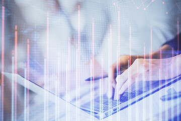 Double exposure of woman hands typing on computer and forex chart hologram drawing. Stock market invest concept.