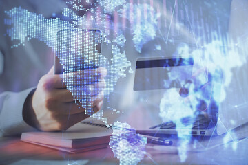 Double exposure of man hands holding a credit card and Forex graph drawing. Stock trading and digital fintech in Internet E-commerce concept.