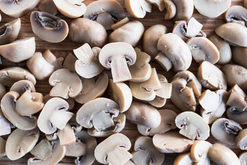 simple food ingredients, champignon mushrooms cut in halves on chopping board