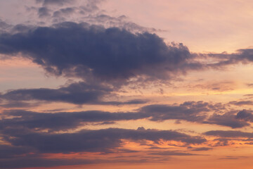 Naklejka na ściany i meble Beautiful bright colorful pink red yellow clouds on dark sky at sunset or sunrise. Evening, morning sky natural eco background. Amazing nature texture surface wallpaper. Dramatic sky.