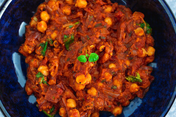 plant-based food, vegan moroccan chickpea stew with tomato sauce onion an carrots