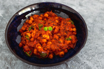 plant-based food, vegan moroccan chickpea stew with tomato sauce onion an carrots