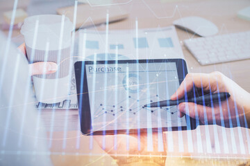 Double exposure of man's hands holding and using a phone and financial chart drawing. Market analysis concept.