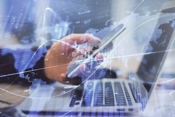 Double exposure of man's hands holding and using a phone and financial graph drawing. Analysis concept.