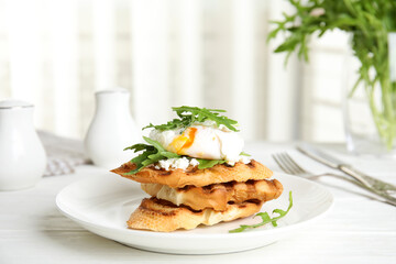 Delicious sandwich with arugula and egg on white wooden table
