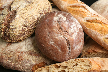 Different kinds of fresh bread as background, closeup