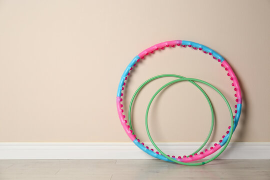 Hoops near beige wall in gym. Space for text