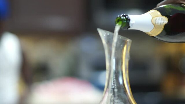 Decanter getting filled with Champagne
