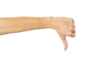 Thumb down. Woman hand gesturing isolated on white