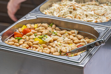 white beans stew cooking steaming during hotel brunch buffet outdoor Catering Dining Eating Party Sharing Concept