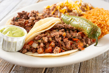 A view of a plate of carne asada tacos.