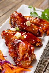 A view of an appetizer plate of Asian BBQ wings.