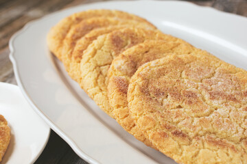 A view of a platter of sugar cookies, in a restaurant or kitchen setting.
