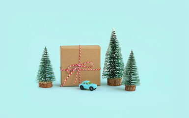 gift box, toy car and christmas tree on blue background. Christmas and New Year holiday concept. winter festive season.  - Powered by Adobe