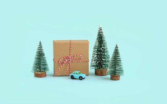 gift box, toy car and christmas tree on blue background. Christmas and New Year holiday concept. winter festive season. 